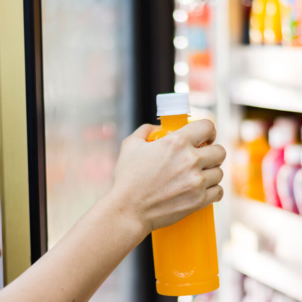 Person grabbing a beverage from retail store