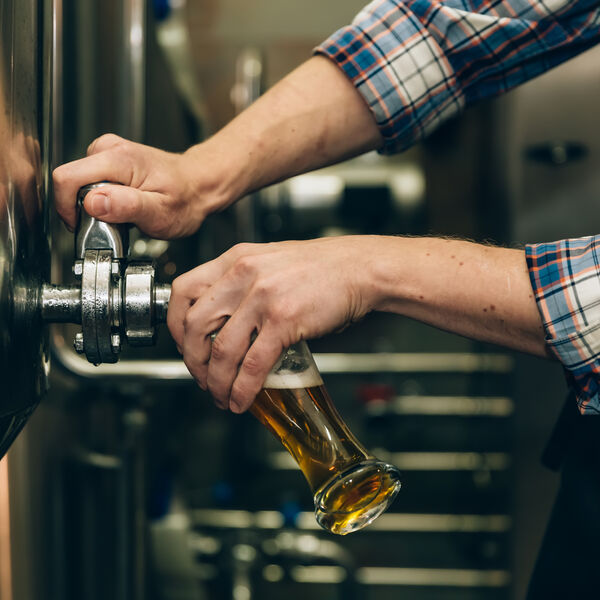 Man pouring beer into glass