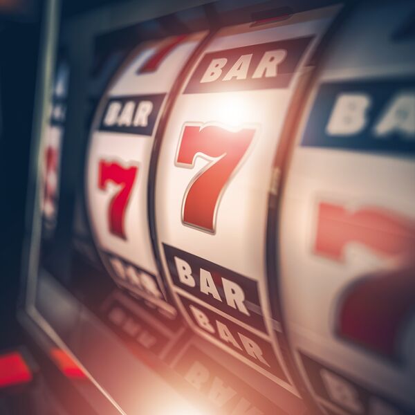 Slot machine displaying three 7s