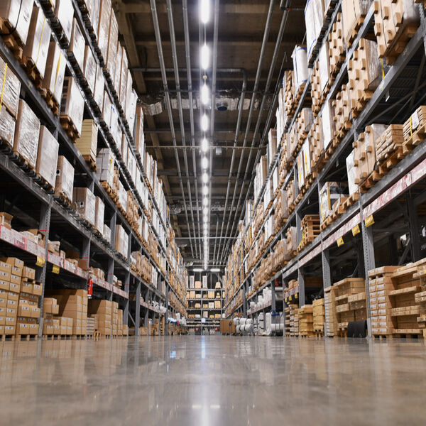 Inside of a distribution center with a lot of boxes  on shelves