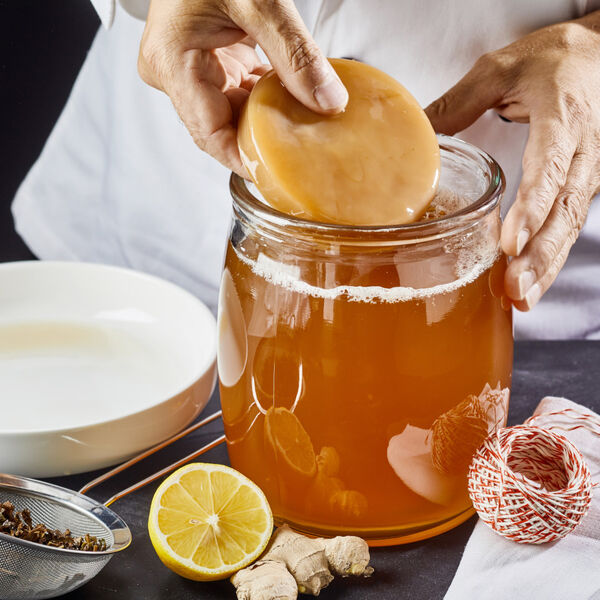 Person making kombucha