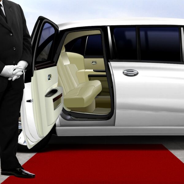 Limo driver opening door to white limousine