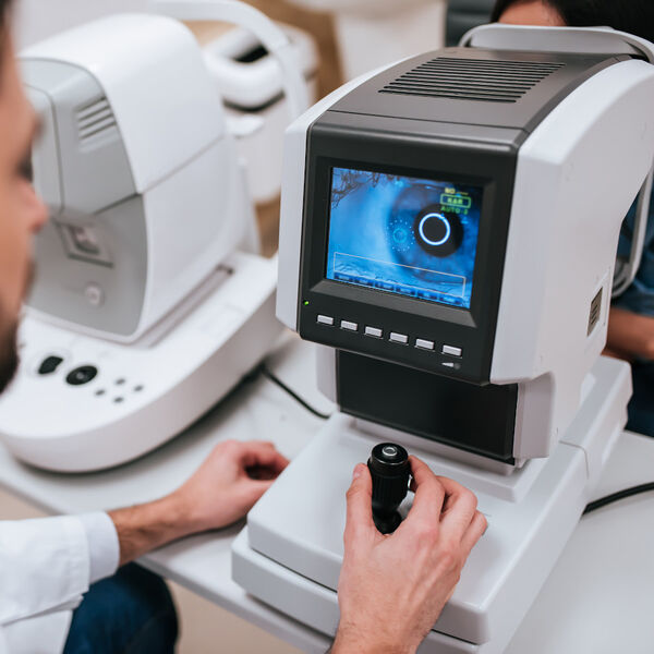 Male optometrist examining eyes