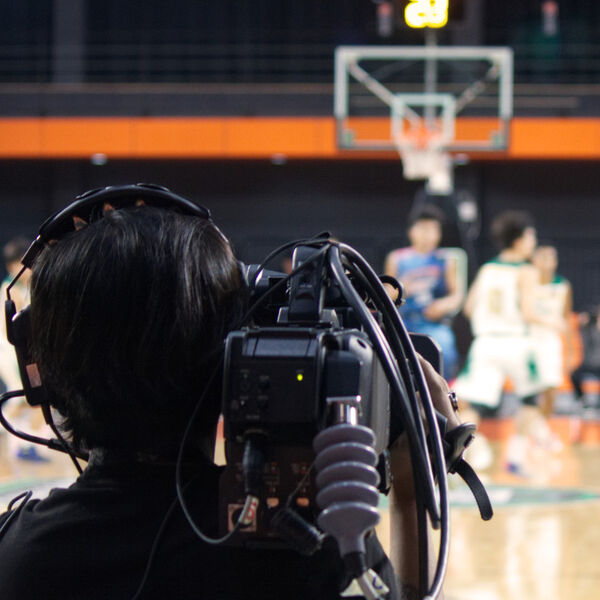 Videographer recoding a basketball game