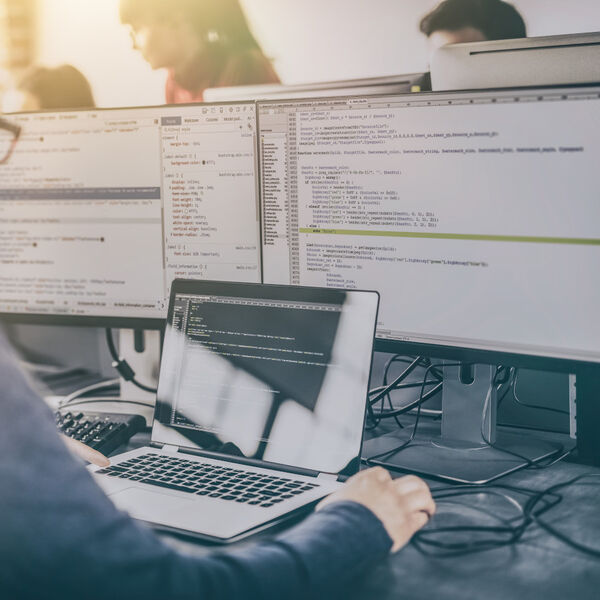 Man in front of multiple screens